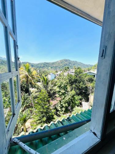 an open window with a view of palm trees at New Blue Mount View Kandy in Kandy