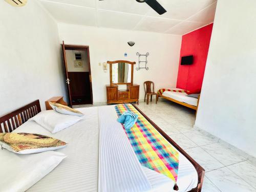 a bedroom with a bed with a blanket on it at New Blue Mount View Kandy in Kandy