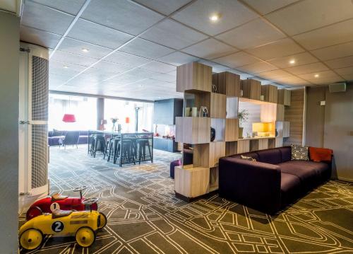a living room with a couch and a childs toy at Scandic Kalmar in Kalmar
