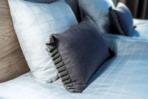 a pillow on a bed with white pillows at Scandic Winn in Karlstad