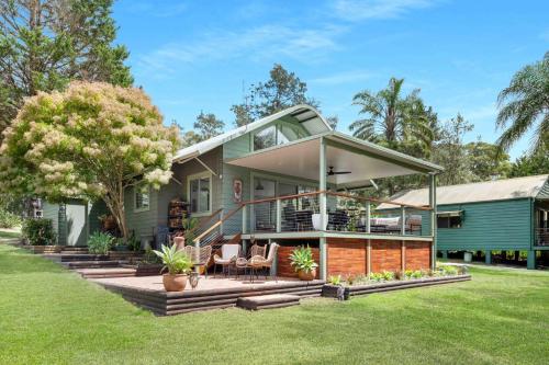 a home with a wrap around porch with a deck at Owl House in Kangaroo Valley