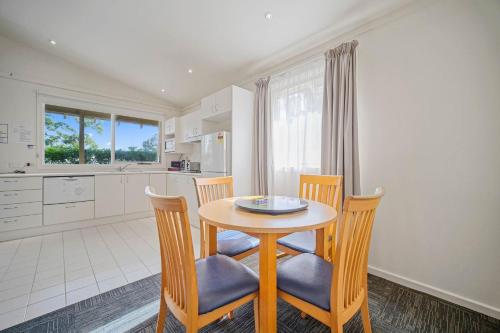 a kitchen and dining room with a table and chairs at Shores Beach & Lakeside Villas in Elizabeth Beach
