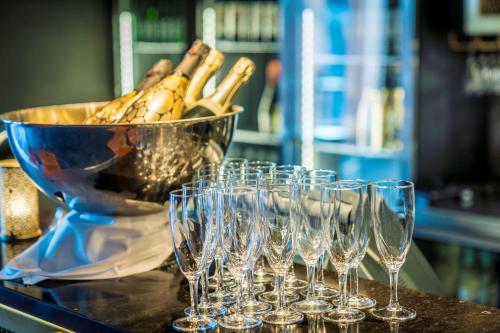 a group of wine glasses on a counter with a bowl at Scandic Frimurarehotellet in Linköping