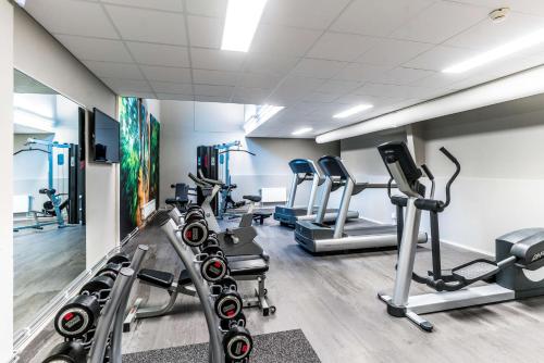 a gym with several treadmills and cardio machines at Scandic Frimurarehotellet in Linköping
