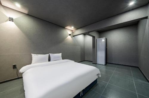 a large white bed in a room with lights at Moonstay Hotel Cheonan in Cheonan