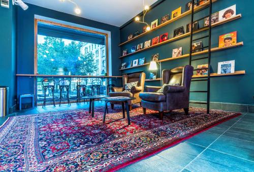a living room with two chairs and a table on a rug at Scandic Stortorget in Malmö