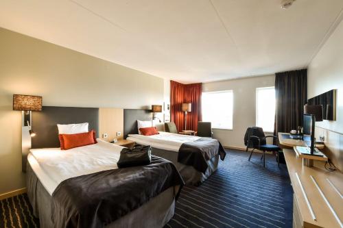 a hotel room with two beds and a television at Scandic Triangeln in Malmö