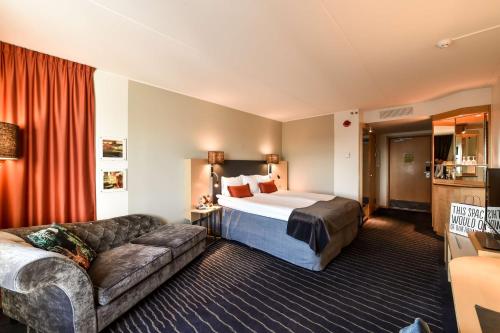 a hotel room with a bed and a couch at Scandic Triangeln in Malmö