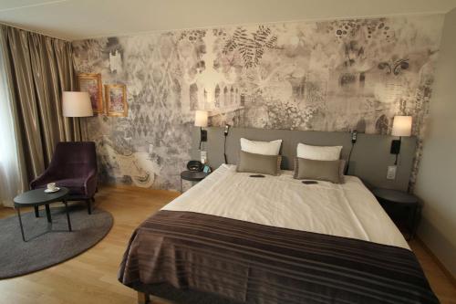 a bedroom with a large bed and a chair at Scandic Triangeln in Malmö