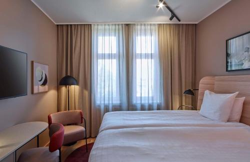 a hotel room with a large bed and a window at Scandic Strömmen in Norrköping
