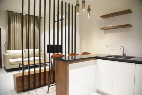 a kitchen with a table and chairs and a couch at Hunkal Stays in Chikmagalūr
