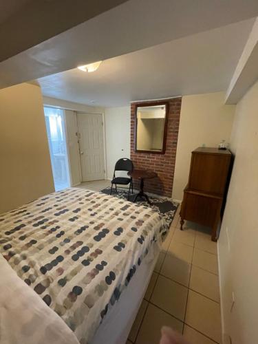 a bedroom with a bed and a desk and a chair at Linda guesthouse in Vancouver