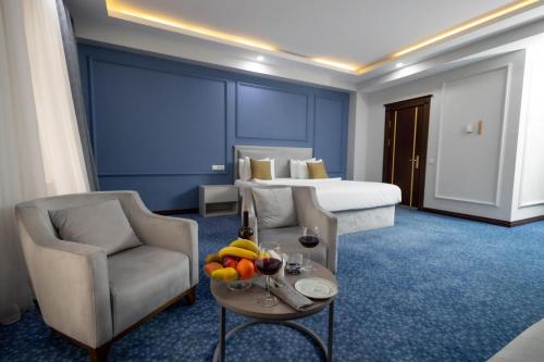 a hotel room with a bed and a table with fruit on it at Grand Hotel Baku Central Park in Baku