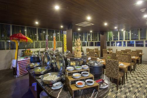 ein Restaurant mit einem Buffet auf einem Tisch in der Unterkunft The Lerina Hotel Nusa Dua in Nusa Dua
