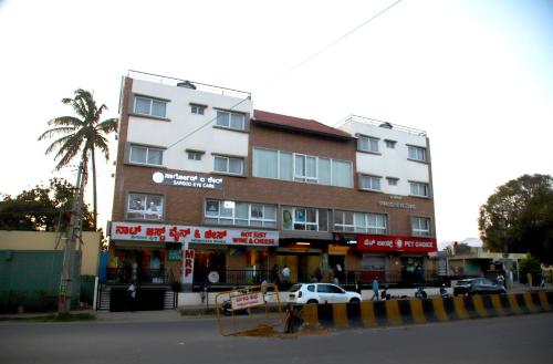a building with a car parked in front of it at Hunkal Stays in Chikmagalūr