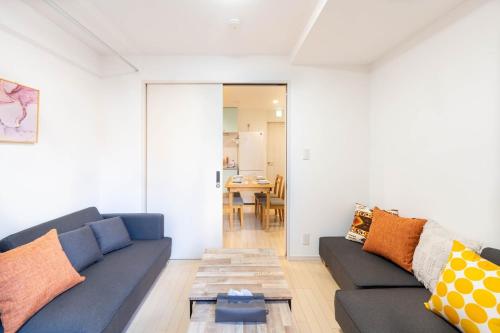 a living room with a couch and a table at 夢の宿 翼 132t in Tokyo