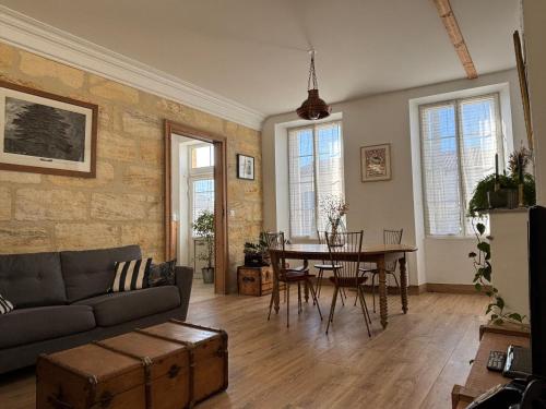 a living room with a couch and a table at Château La Fon du Berger in Saint-Sauveur