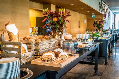 a buffet line with loaves of bread and pastries at Scandic Talk in Stockholm
