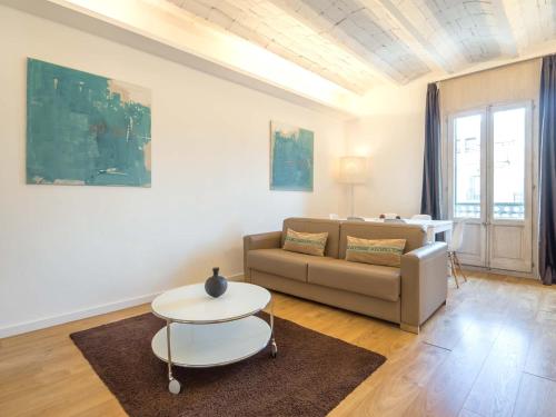 a living room with a couch and a table at Rent Top Apartments Rambla Catalunya in Barcelona