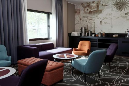 a living room with a couch and chairs and a table at Scandic Västerås in Västerås