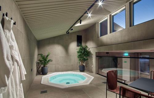 a large bathroom with a jacuzzi tub in a room at Scandic Grand Hotel in Örebro