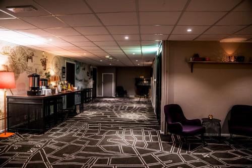 a lobby with a corridor with chairs and a bar at Scandic Östersund Syd in Östersund