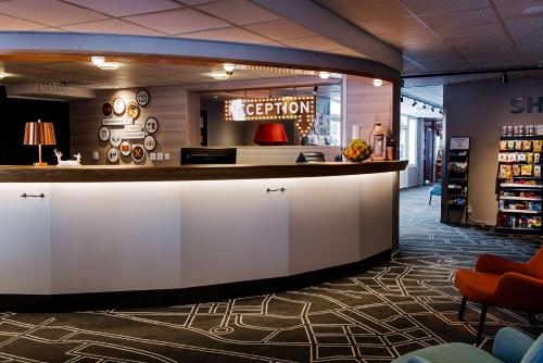 a lobby of a store with a reception counter at Scandic Östersund Syd in Östersund
