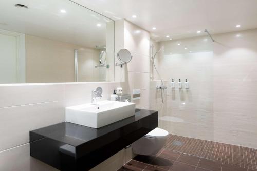 a bathroom with a sink and a shower and a toilet at Scandic Stavanger Park in Stavanger