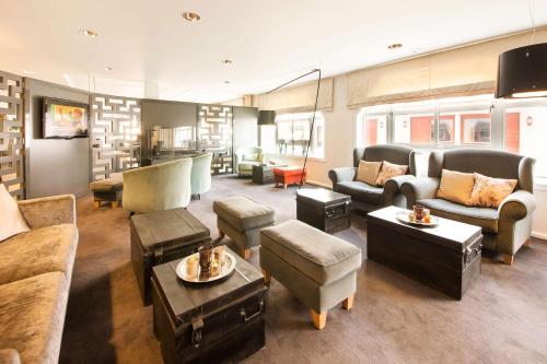 a large living room with couches and chairs at Scandic Bryggen in Honningsvåg