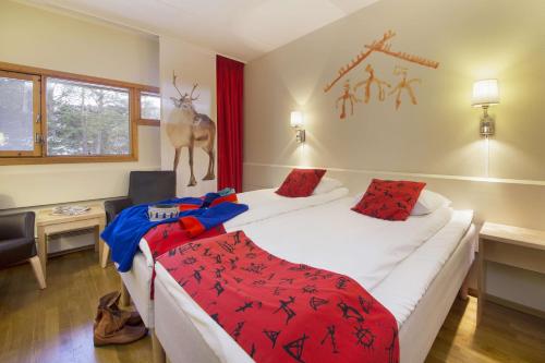 a hotel room with two beds and a deer on the wall at Scandic Karasjok in Karasjok