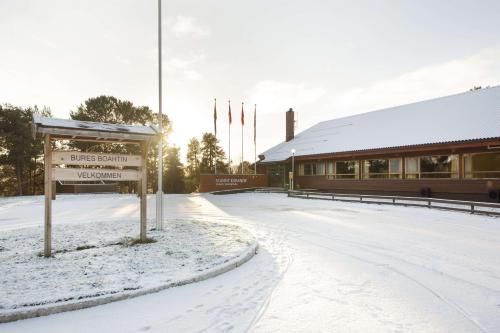 a sign in the snow in front of a building at Scandic Karasjok in Karasjok