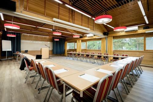 a conference room with a long table and chairs at Scandic Karasjok in Karasjok