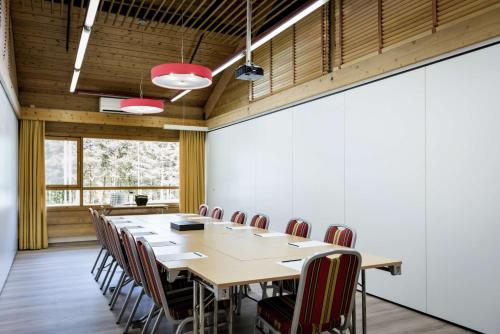 a conference room with a long table and chairs at Scandic Karasjok in Karasjok