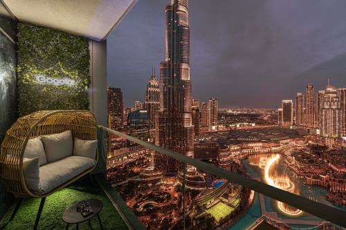 a room with a view of a city at night at Gogoto1 Ultra LUX Burj View Spacious High Floor PS5 NYE Fireworks View in Dubai