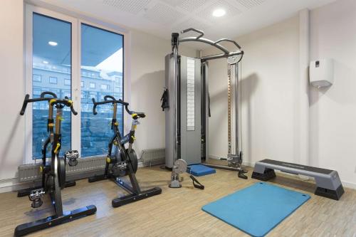 a gym with treadmills and exercise bikes in a room at Scandic Narvik in Narvik