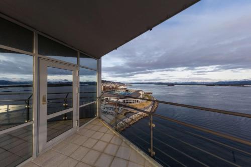 a balcony on a cruise ship looking out over the water at Scandic Seilet Hotel in Molde