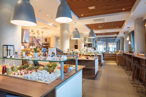 a buffet line in a restaurant with food on display at Scandic Seilet Hotel in Molde