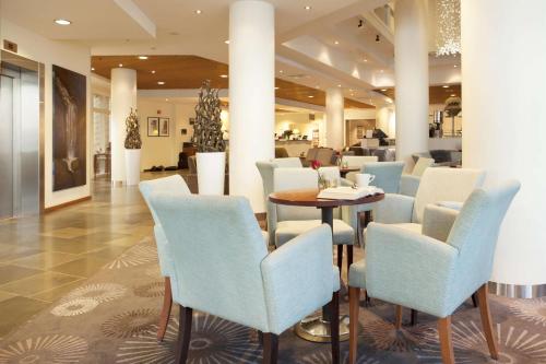 a restaurant with chairs and a table in a lobby at Scandic Seilet Hotel in Molde