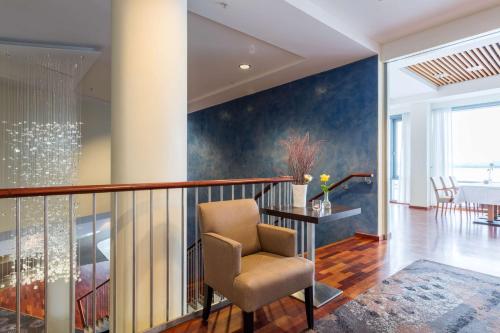 a living room with a chair on a balcony at Scandic Seilet Hotel in Molde