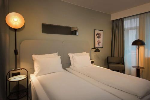 เตียงในห้องที่ Scandic Victoria Lillehammer
