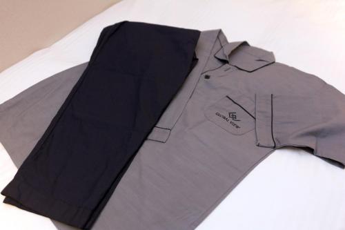 a gray shirt and a black tie on a table at Hotel Global View Hachinohe Annex in Hachinohe