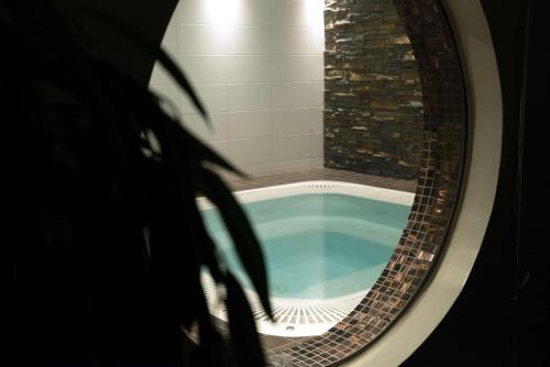 a round bath tub in a bathroom with a window at Scandic Karlstad City in Karlstad