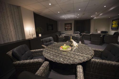a dining room with a table and chairs with a bowl of fruit at Scandic Karlstad City in Karlstad