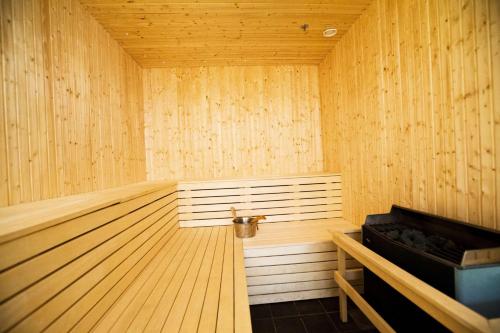 a large wooden sauna with a wooden floor and a wooden at Scandic Karlstad City in Karlstad