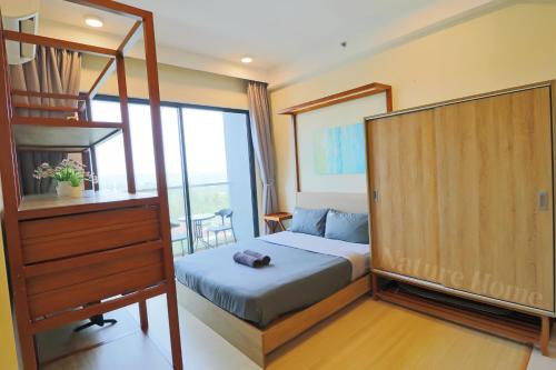 a bedroom with a bunk bed and a ladder at Timurbay Seafront Residences by Nature Home in Kuantan