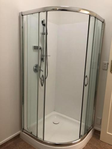a shower with a glass enclosure in a bathroom at Smart Value Premium Alpine Stay Strictly Smoke, Vape & Pet Free in Methven