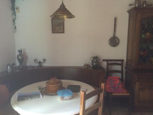 a dining room with a table and a table and chairs at U Palazzu Corte in Corte