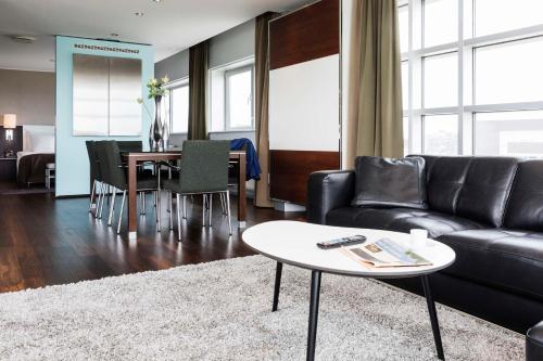 a living room with a couch and a table at Scandic Sluseholmen in Copenhagen