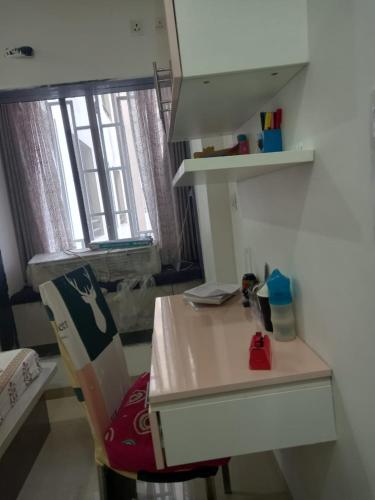 a white desk in a room with a window at Stay comfort at City Heart 2Bhk AC ,WIFI & Much more in Indore