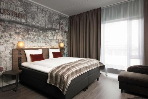 a bedroom with a large bed and a large window at Scandic Lillestrøm in Lillestrøm